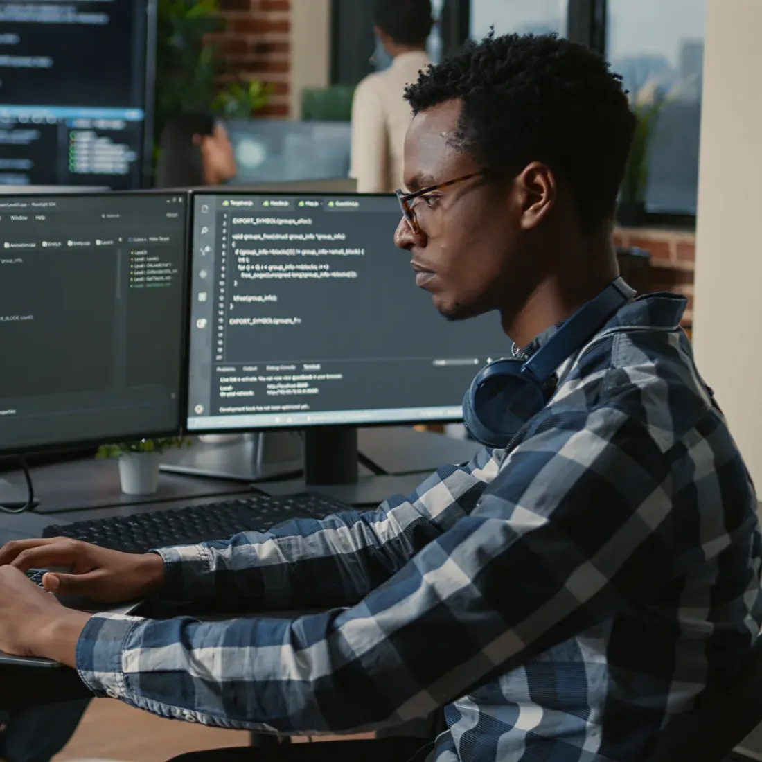 A skilled IT professional working at a code workstation
