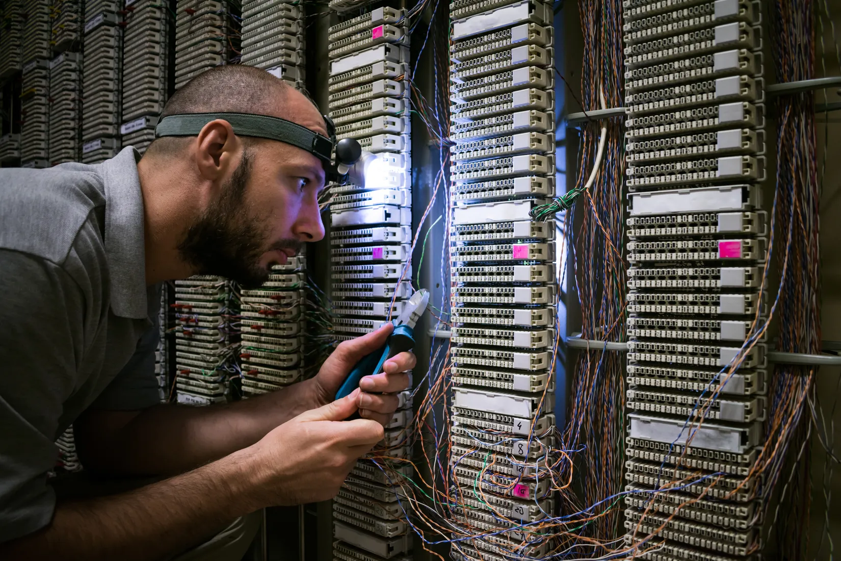 A technician working on structured network cabling