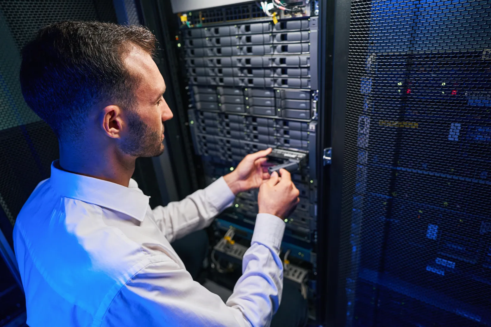 A technician installing a drive into a storage array