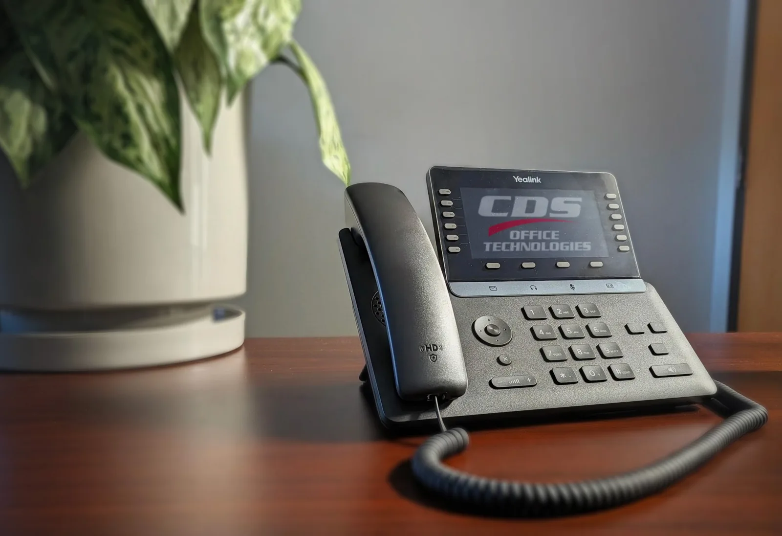 A CDS-branded Yealink VoIP desk phone on an office desk